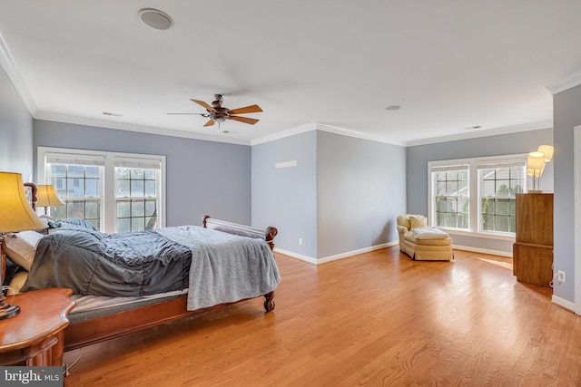 bedroom with light hardwood / wood-style floors, ceiling fan, and crown molding