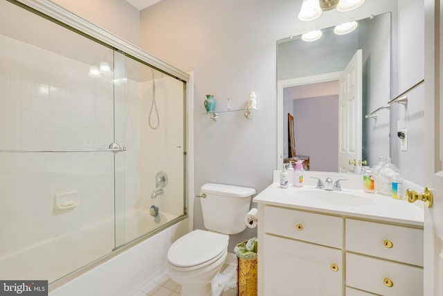 full bathroom featuring shower / bath combination with glass door, tile patterned flooring, vanity, and toilet