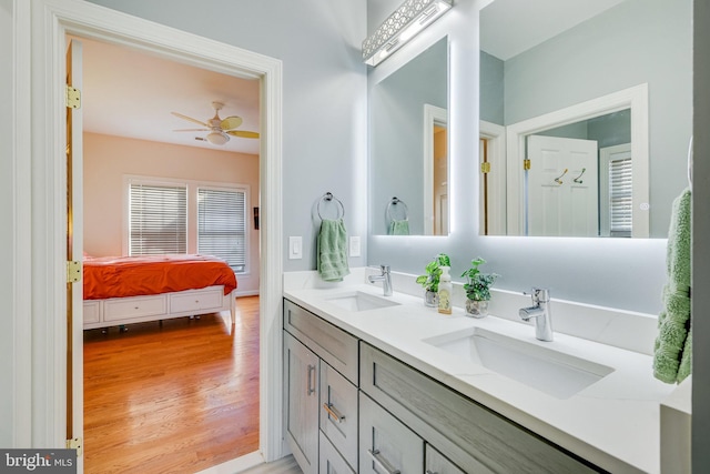 bathroom featuring ceiling fan, vanity, and wood-type flooring