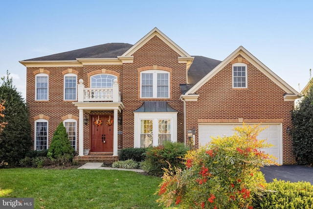 view of front of house with a balcony, a front yard, and a garage