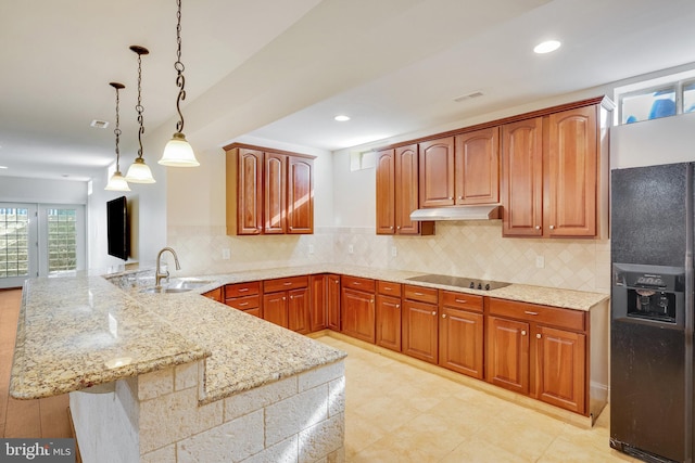 kitchen with black appliances, sink, hanging light fixtures, tasteful backsplash, and kitchen peninsula