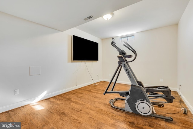 exercise room featuring hardwood / wood-style floors