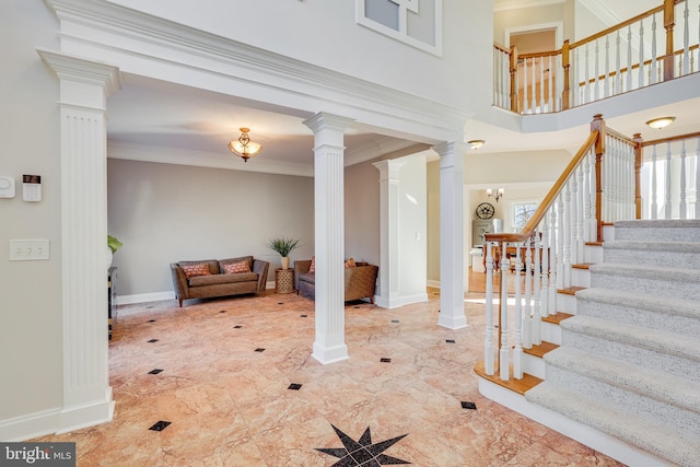 entryway featuring crown molding and a notable chandelier