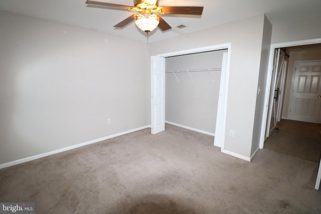 unfurnished bedroom with ceiling fan, a closet, and carpet floors