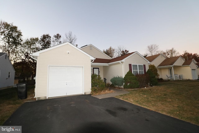 view of front facade featuring a lawn and a garage