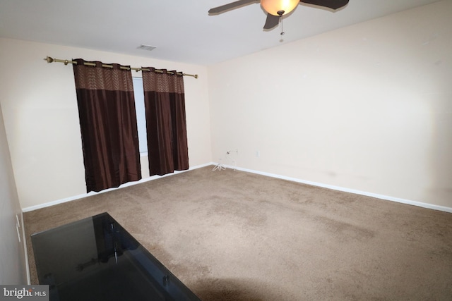 unfurnished room with carpet and ceiling fan