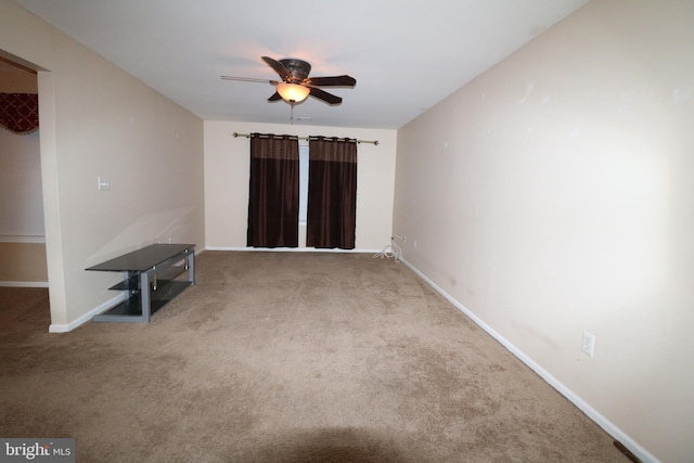 unfurnished living room with ceiling fan and carpet floors