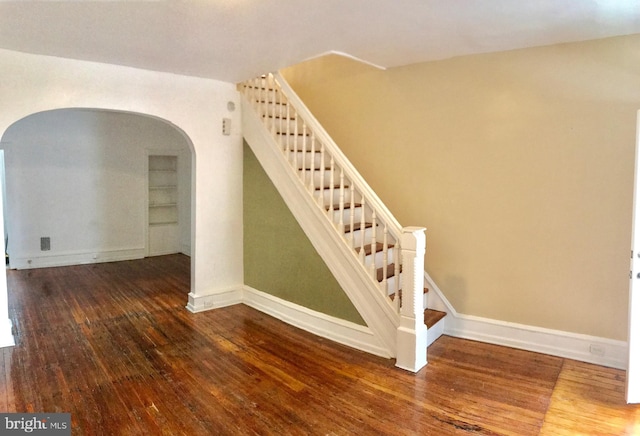 stairway with hardwood / wood-style floors