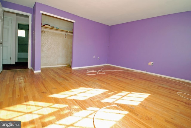 unfurnished bedroom with a closet and hardwood / wood-style floors