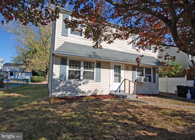 view of front of property featuring cooling unit and a front yard