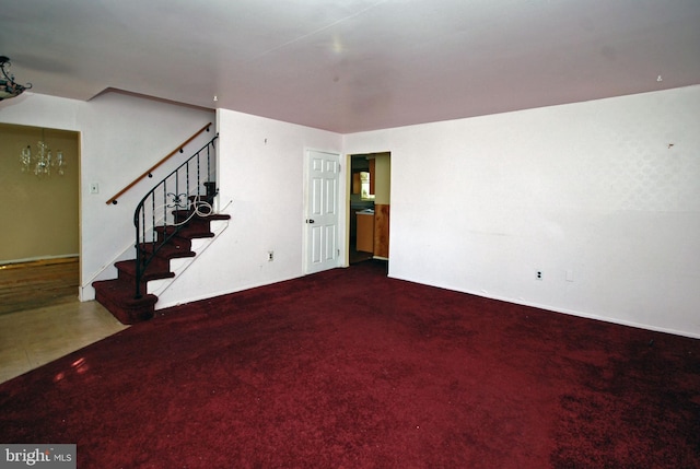 interior space with carpet and an inviting chandelier