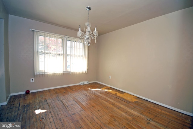 unfurnished room with a chandelier and dark hardwood / wood-style flooring