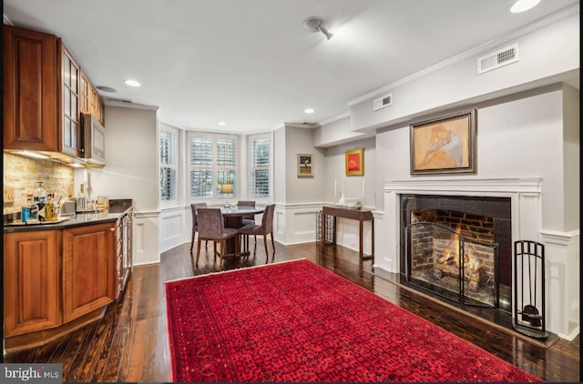 interior space with dark hardwood / wood-style floors and ornamental molding