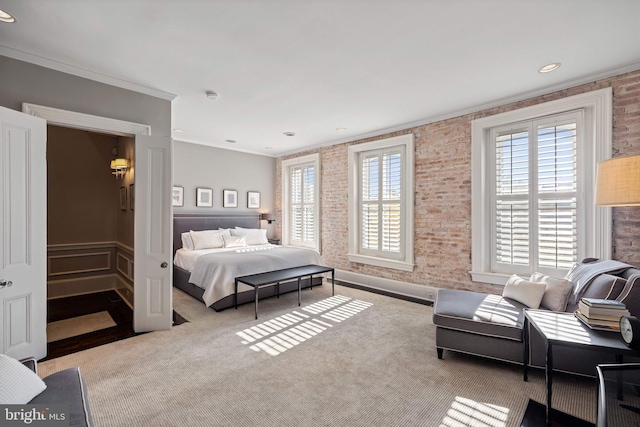 carpeted bedroom featuring ornamental molding and brick wall