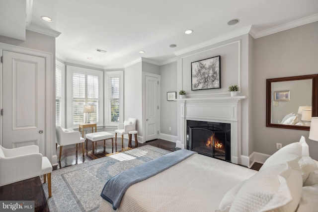 bedroom with hardwood / wood-style floors and crown molding