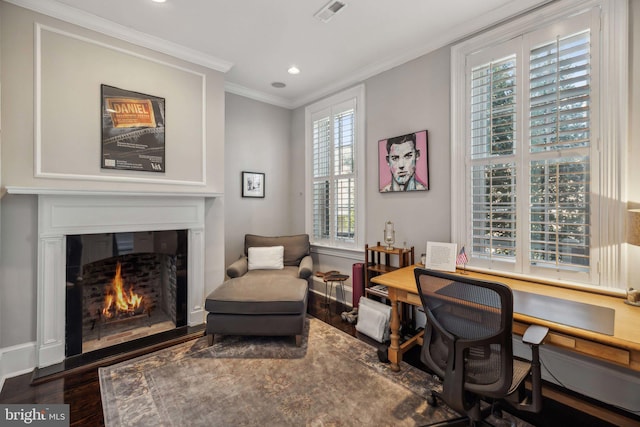 home office featuring a healthy amount of sunlight, crown molding, and wood-type flooring