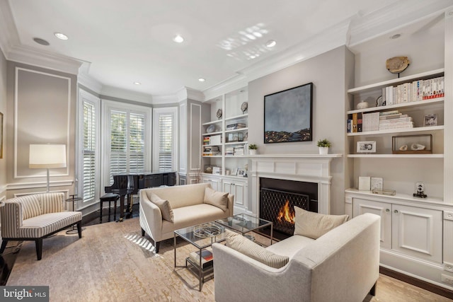 living room featuring built in shelves, light wood-type flooring, and crown molding