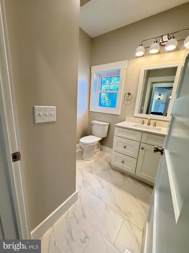 bathroom featuring vanity and toilet