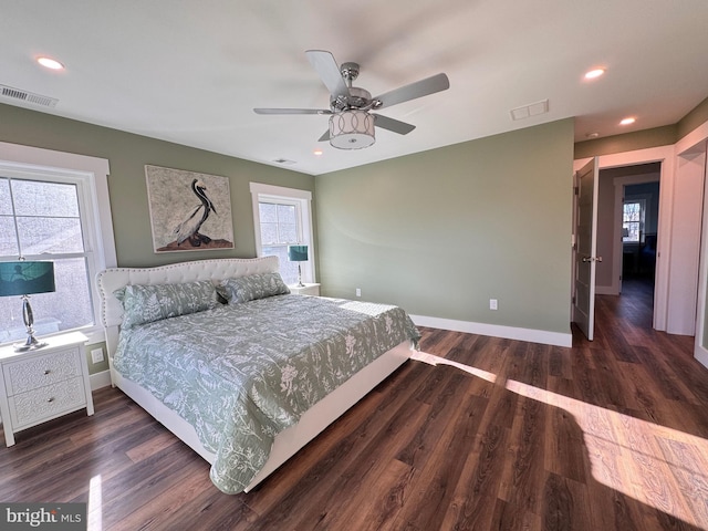 bedroom with ceiling fan and dark hardwood / wood-style flooring