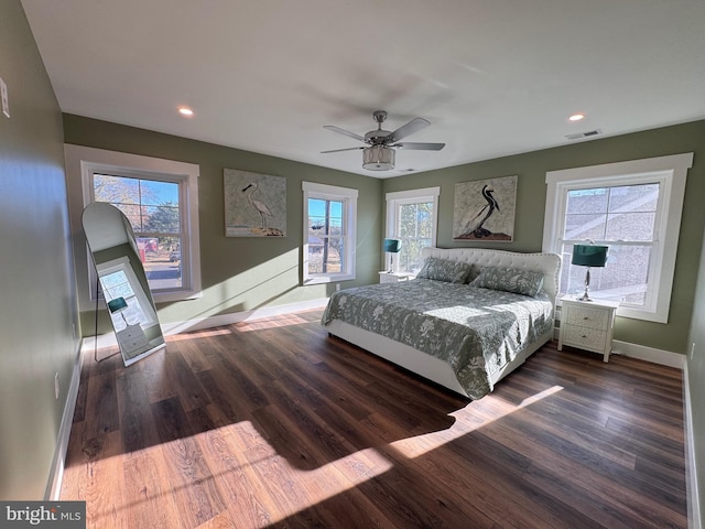 unfurnished bedroom with dark wood-type flooring, ceiling fan, and multiple windows