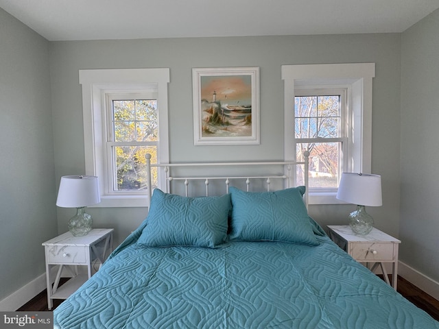 bedroom featuring hardwood / wood-style flooring and multiple windows