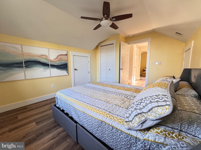 bedroom featuring dark hardwood / wood-style flooring, a closet, vaulted ceiling, and ceiling fan