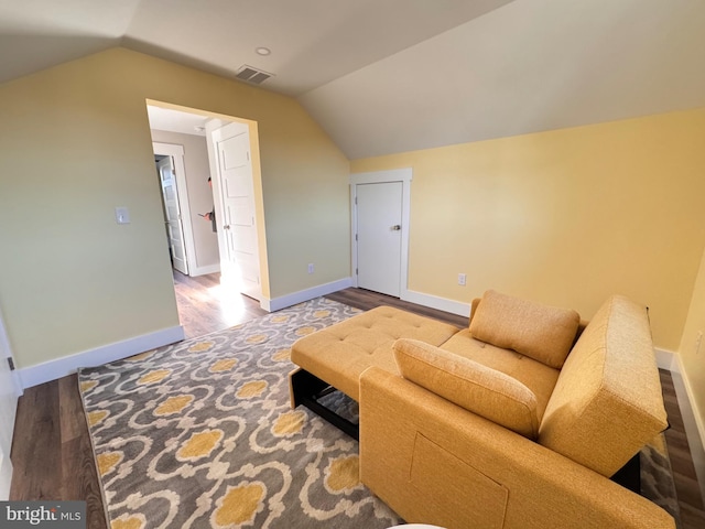 living area with wood-type flooring and vaulted ceiling