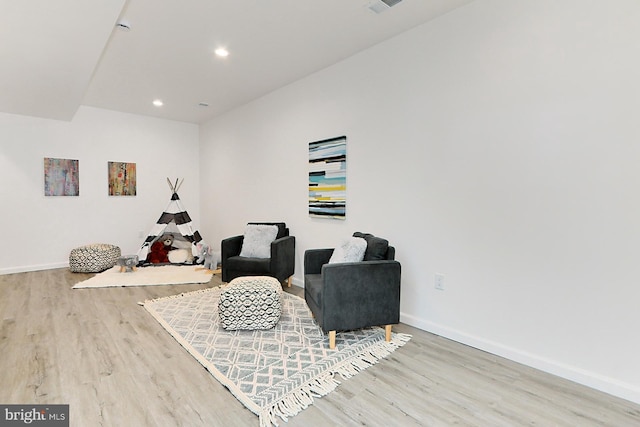 sitting room with hardwood / wood-style flooring