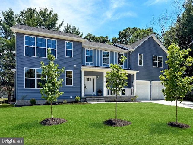 view of front of home featuring a porch, a garage, and a front lawn