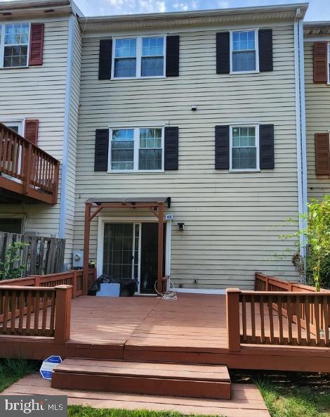 rear view of property featuring a deck