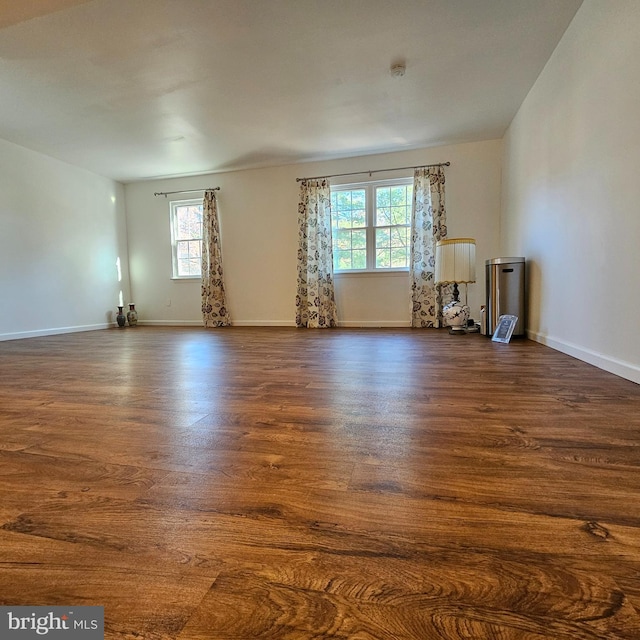 unfurnished room featuring dark wood-type flooring