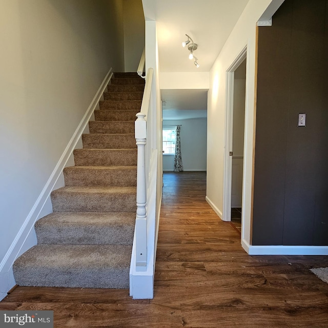 stairs featuring wood-type flooring