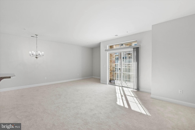 3000 Fountainview Cir Unit 201, Newark, DE 19713 - unfurnished living room featuring carpet floors, a chandelier, and baseboards