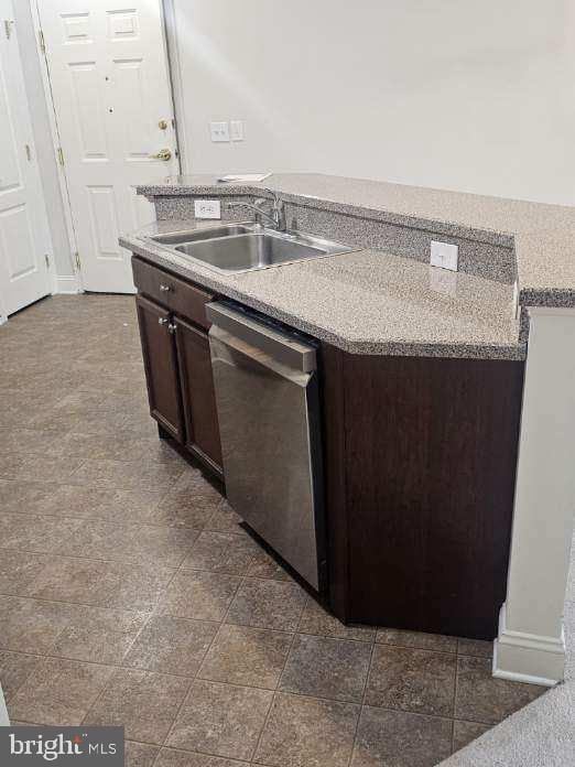 3000 Fountainview Cir Unit 201, Newark, DE 19713 - kitchen with a sink, dishwasher, dark brown cabinetry, a kitchen island with sink, and light countertops