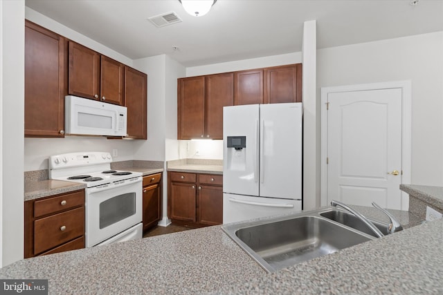 kitchen featuring white appliances and sink