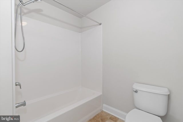 bathroom featuring bathing tub / shower combination and toilet