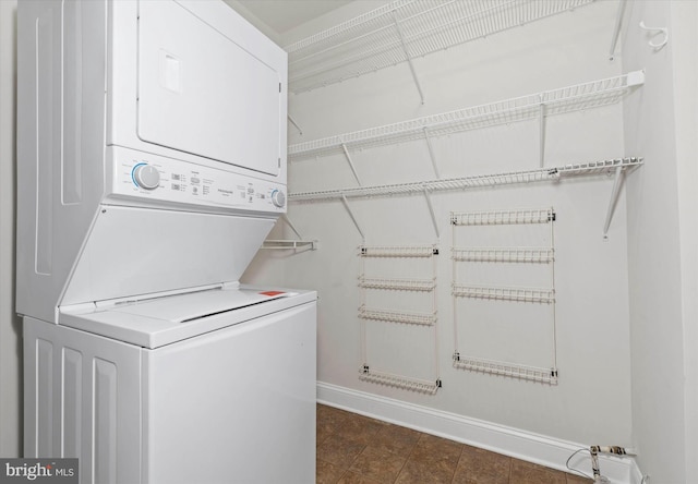 3000 Fountainview Cir Unit 201, Newark, DE 19713 - washroom featuring estacked washer and dryer and baseboards