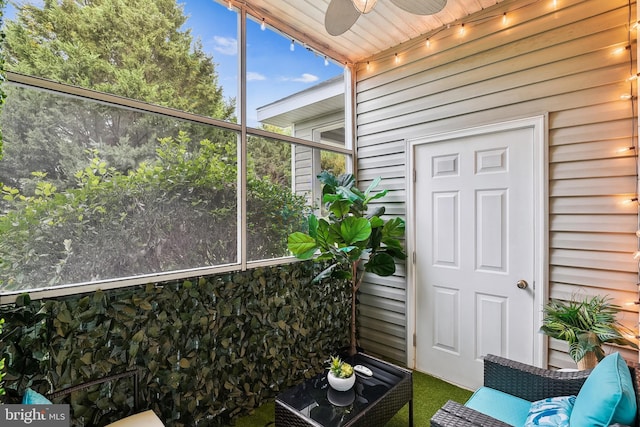 unfurnished sunroom with ceiling fan