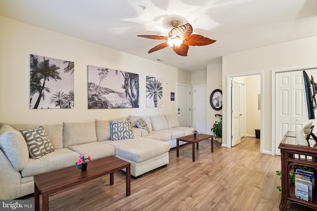 living room with ceiling fan and light hardwood / wood-style floors