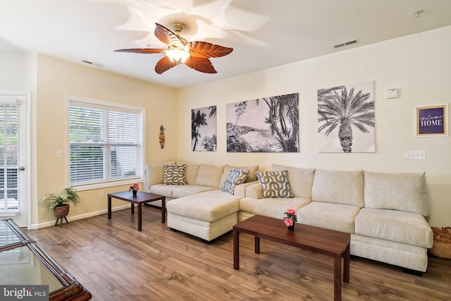 living room with hardwood / wood-style floors and ceiling fan