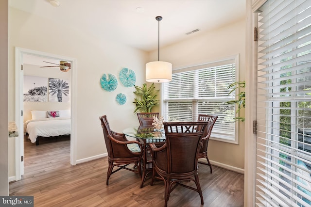 dining room featuring wood-type flooring and ceiling fan