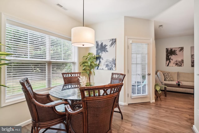 dining area with a wealth of natural light and hardwood / wood-style floors