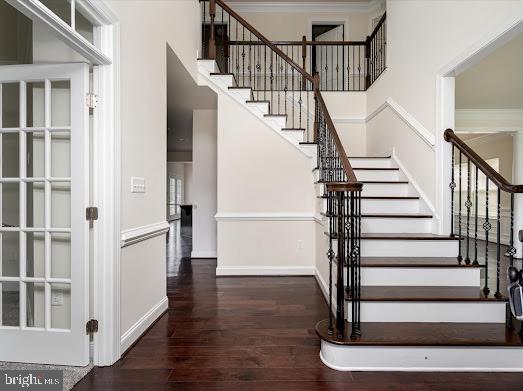 stairs featuring hardwood / wood-style flooring