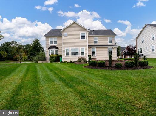 rear view of house with a lawn