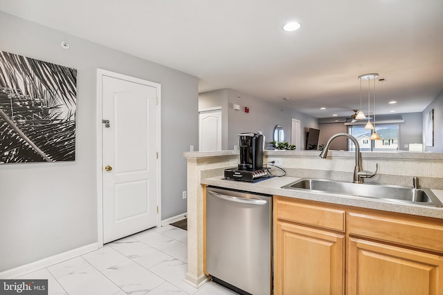 kitchen with hanging light fixtures, sink, and stainless steel dishwasher