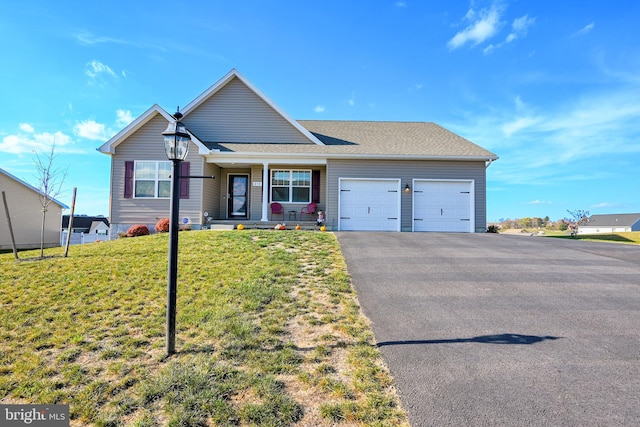 view of front of house with a garage and a front lawn