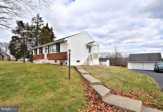 view of side of property featuring an outbuilding and a yard