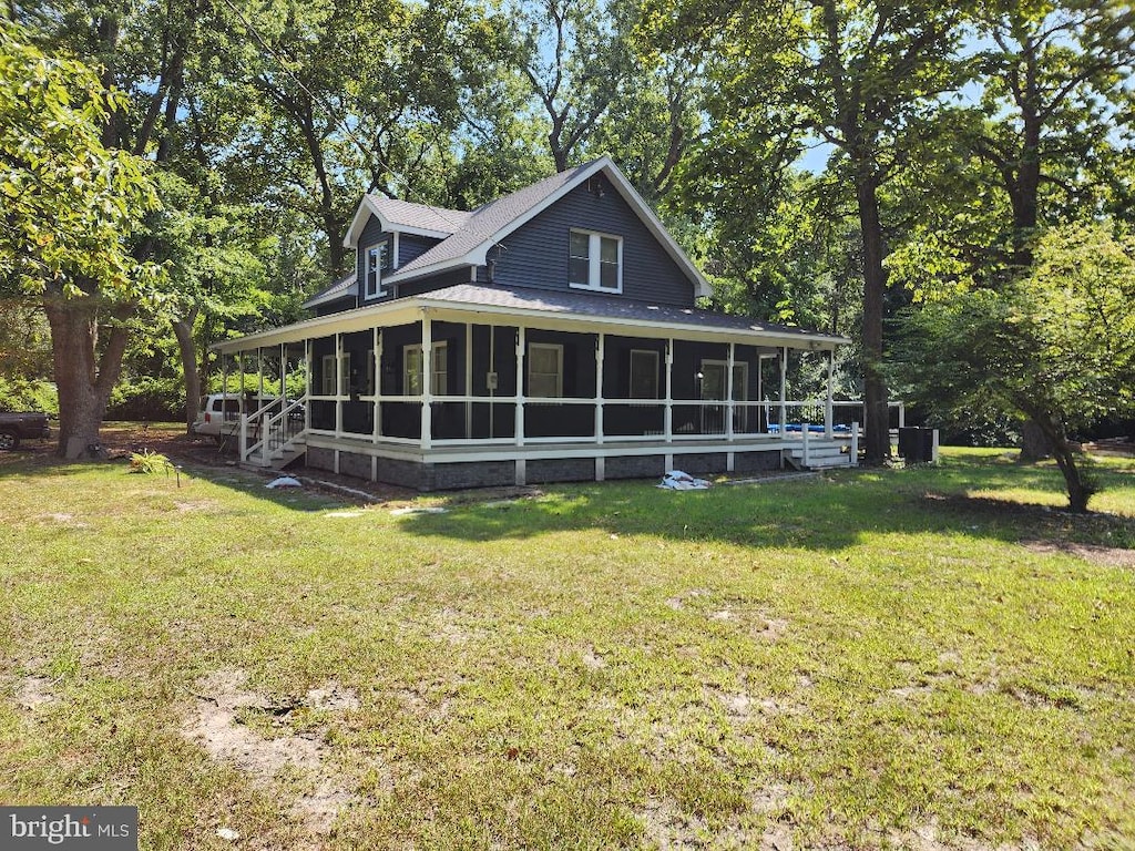 exterior space with a lawn and a sunroom