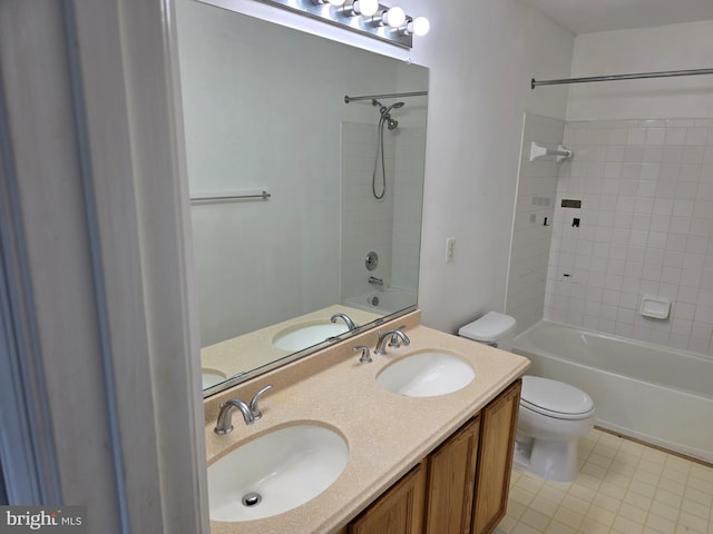 full bathroom with toilet, vanity, and tiled shower / bath