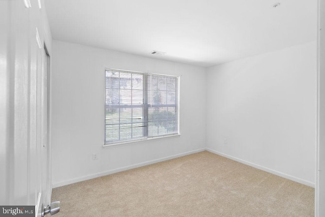 empty room with light colored carpet